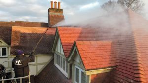 roof cleaners cleaning roof in Surrey