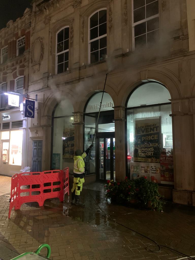 DSW Cleaning team performing façade cleaning in a city centre during the evening.”