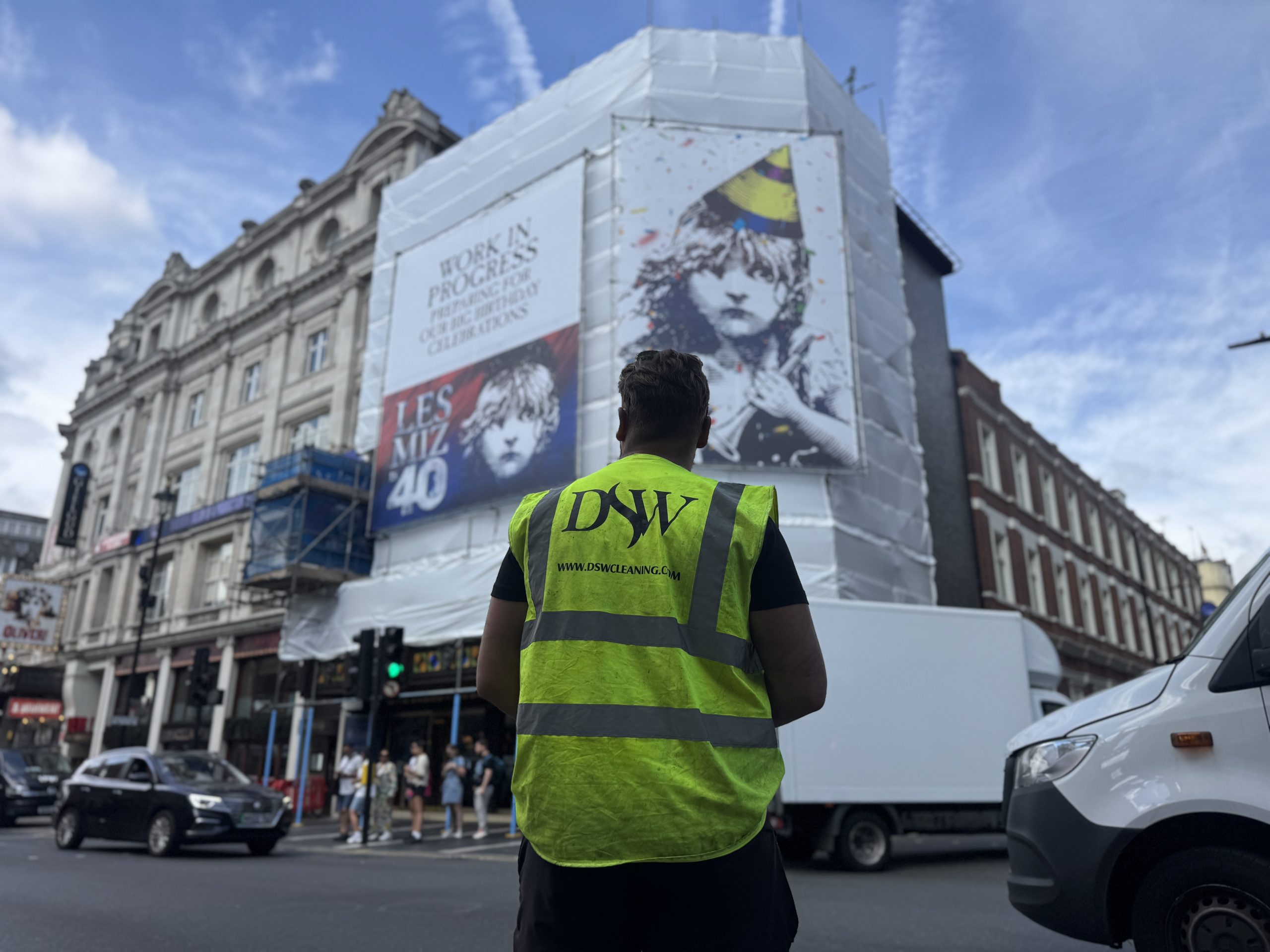 A DSW technician assessing a building prior to delivering large-scale commercial facade cleaning on complex stone buildings using specialist access methods.