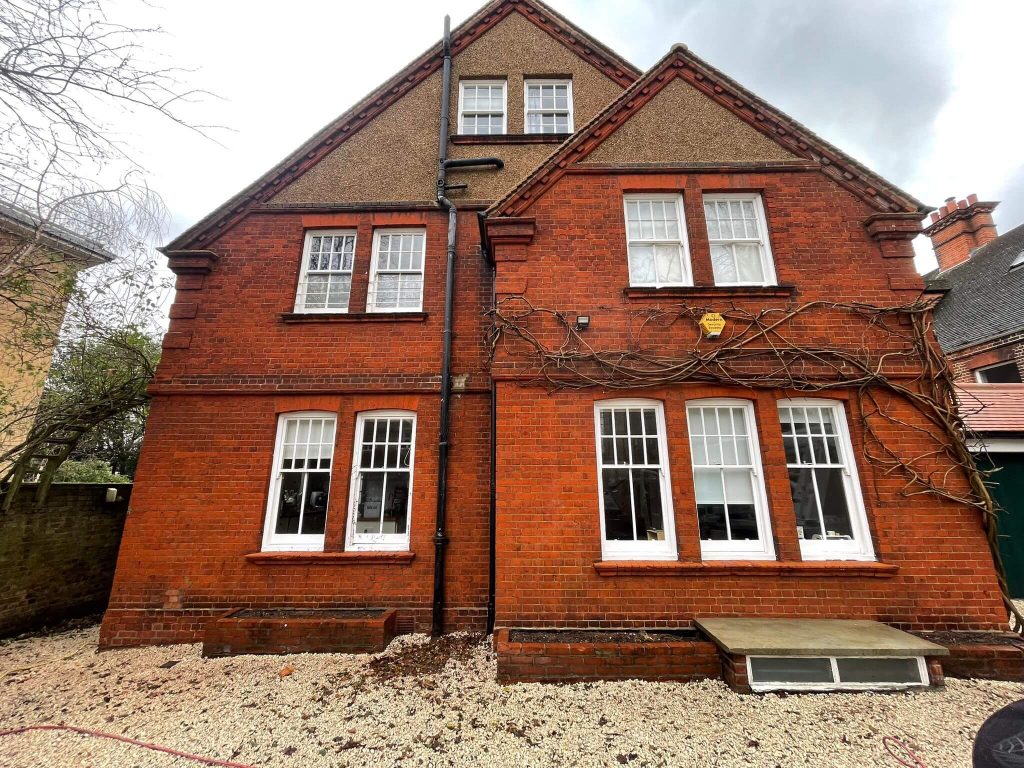 Red brick façade fully cleaned after wisteria removal in South London