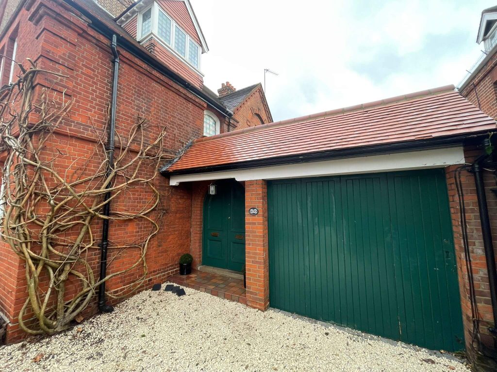 Clean red brick house and garage in South London after professional brick cleaning.